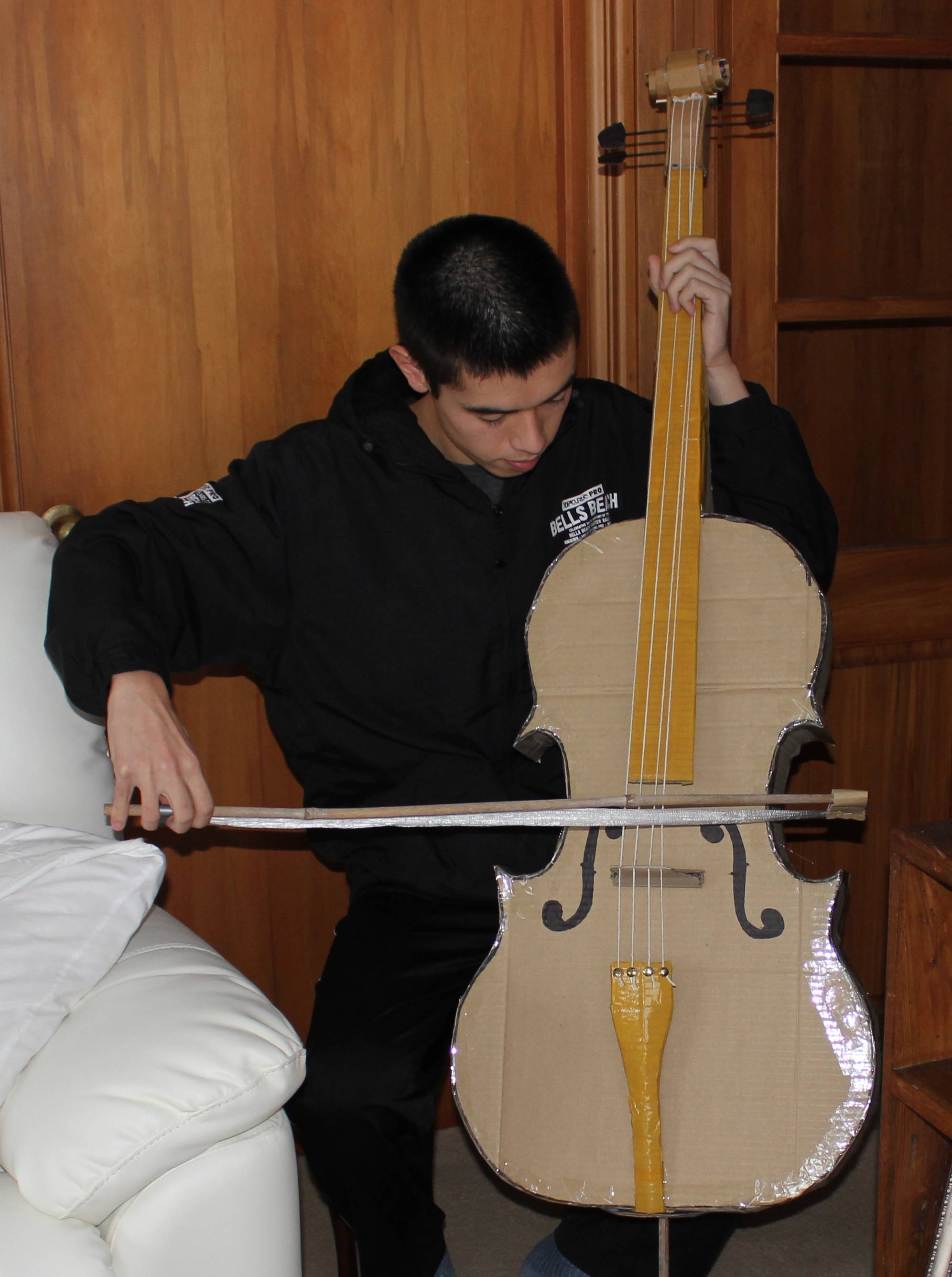 Tom Hackshaw playing a cardbook cello